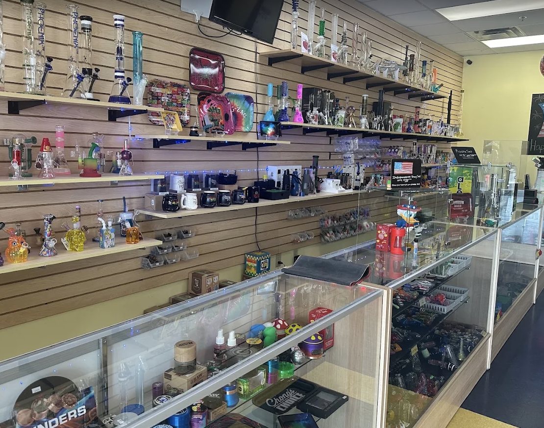 Inside Guided Vision, shelves of glassware and smoking accessories